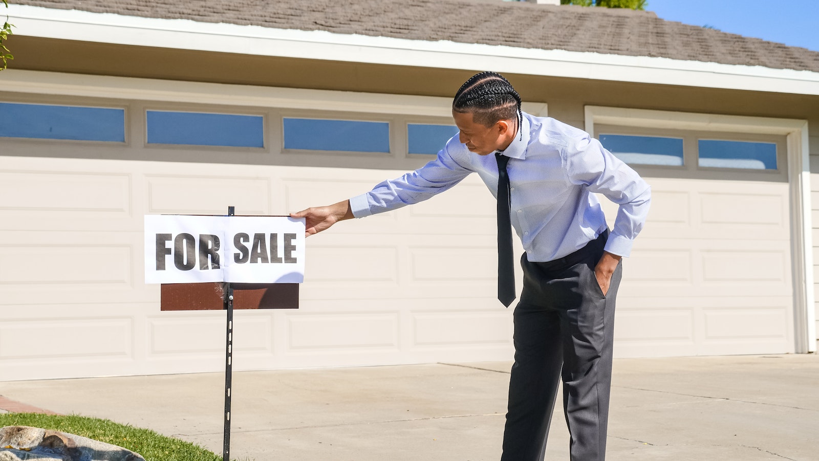 Man in a Dress Shirt Holding a For Sale Signage